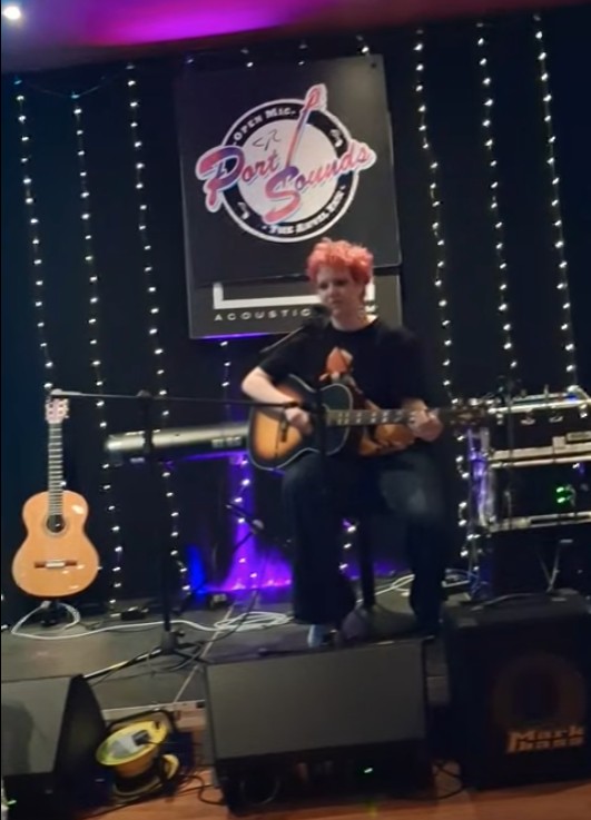 Maeve performing at Port Sounds open mic
